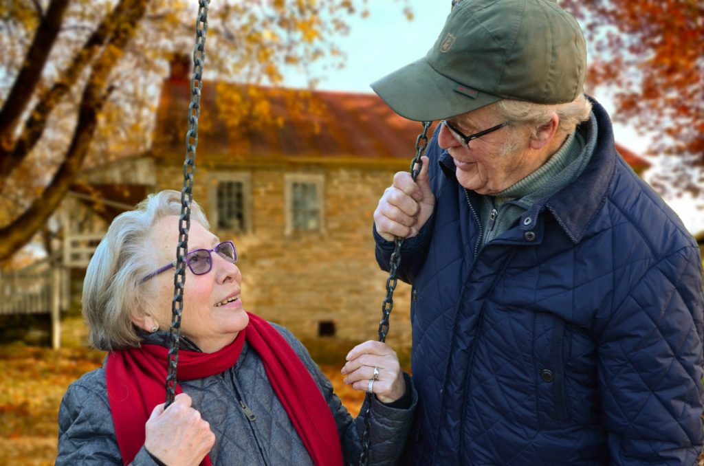 elderly couple outside in the fall